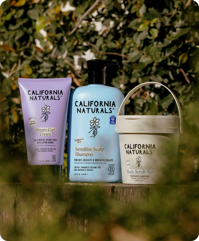 A group of California Naturals bottles and a tub resting in leaves